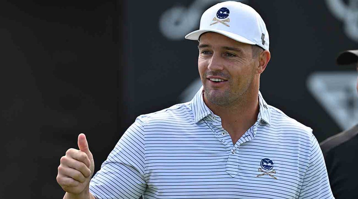 Bryson DeChambeau interacts with fans while warming up during the first round of the 2023 LIV Golf Chicago golf tournament at Rich Harvest Farms